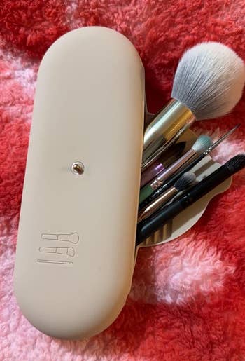 reviewer's makeup brushes in tan holder 