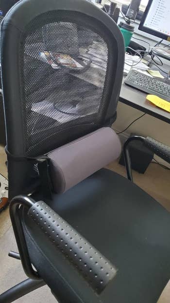 side view of an ergonomic office chair with lumbar roll attached