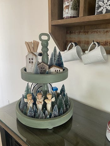 reviewer image of a few mini artificial trees on a mantle piece