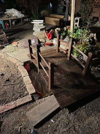 Small woody plot span successful a backyard setting, surrounded by operation materials and plants
