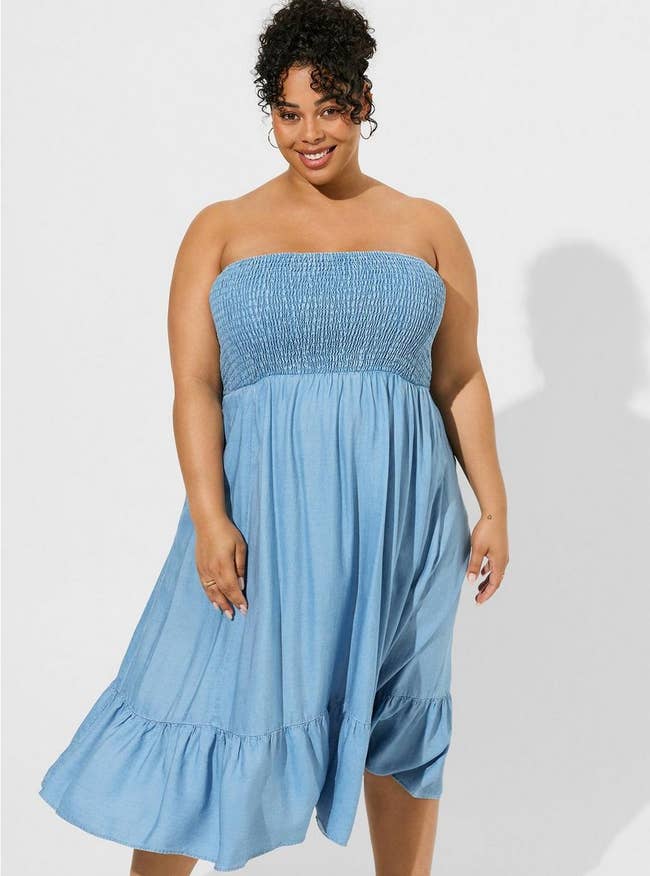 a model in a strapless chambray midi dress