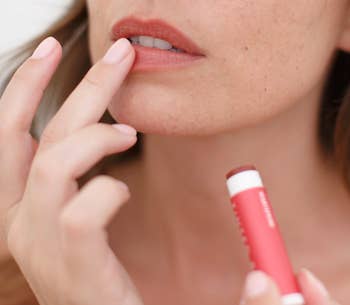 Model applying the lip balm