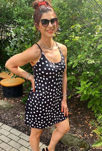 a reviewer wearing the black and white polka dot dress