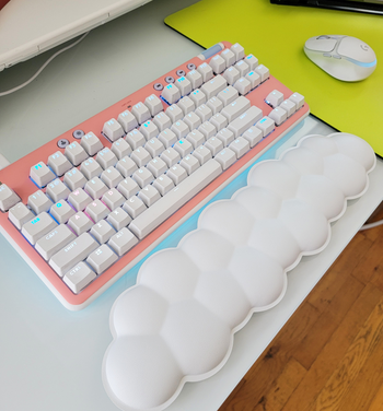 buzzfeed editor's logitech keyboard with pink faceplate and the cloud wrist rest