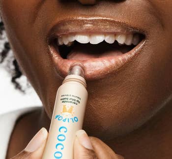 A idiosyncratic applies Cocokind articulator balm labeled for delicate tegument and described arsenic untinted
