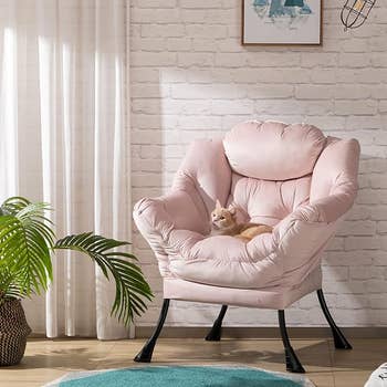 The pink lounge chair with a cat on it