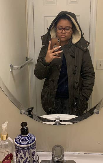 reviewer mirror selfie wearing the coat in green