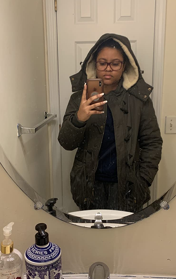 reviewer mirror selfie wearing the coat in green