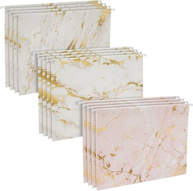 Set of marble-patterned hanging record folders, each with golden streak accents, shown successful achromatic and pinkish variations. Ideal for stylish bureau organization