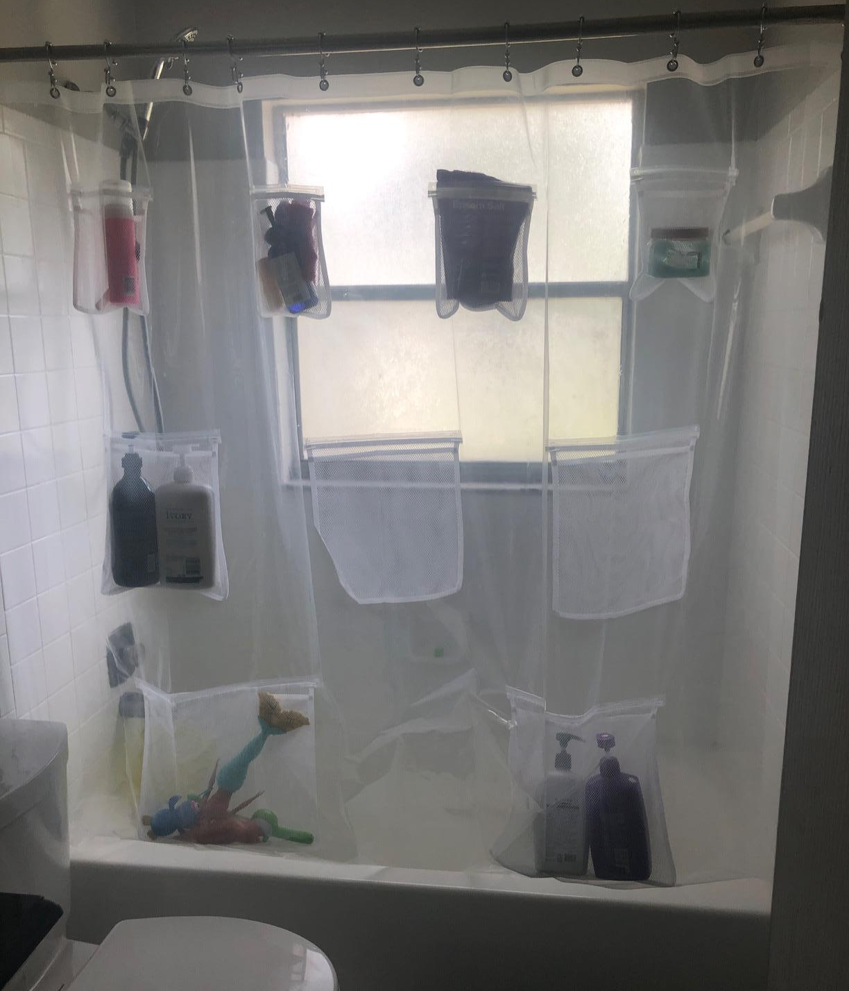 A reviewer's shower curtain, with pockets full of items
