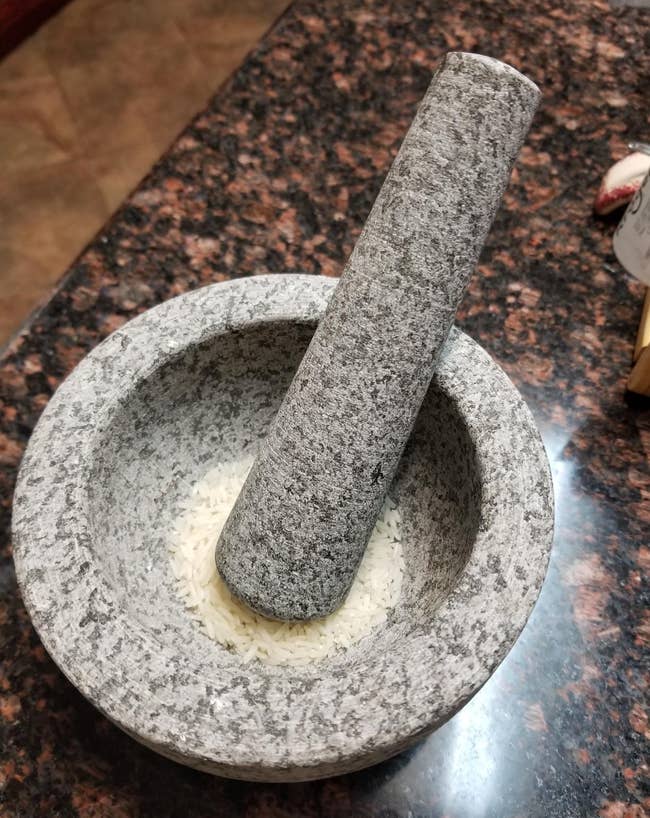 reviewer photo of the gray mortar and pestle containing rice