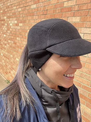 reviewer wearing the hat in black