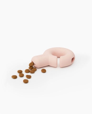 the toy in pink with treats coming out of it