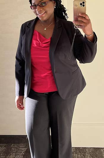 a reviewer wearing the red top with a blazer