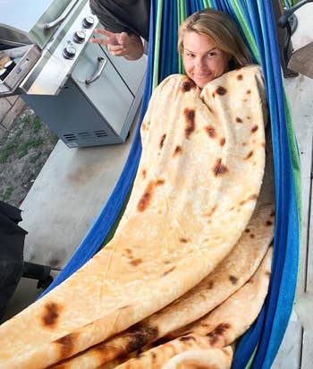 reviewer wrapped up in their blanket that looks like a tortilla