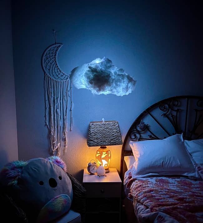 a cloud light hanging over a nightstand