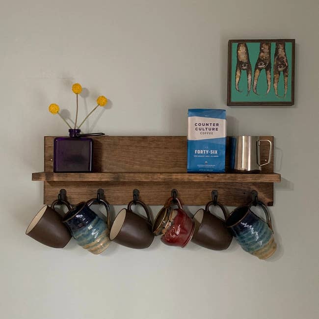 coffee rack on wall holding coffee and mugs