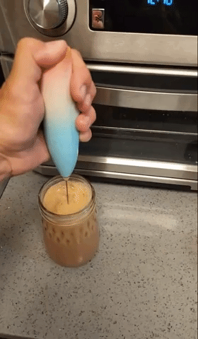 gif of anther reviewer using frother in their coffee