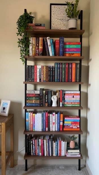 another reviewer's black/oak bookshelf with various arranged books and decorative items on it