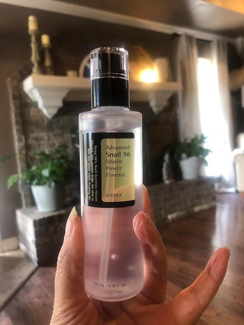 reviewer holding bottle of essence