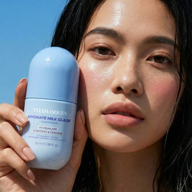 Person holding Vitamasques Hydrate Milk Glaze Moisturizer, showcasing glowing skin, suitable for a buying  nonfiction  connected  skincare products