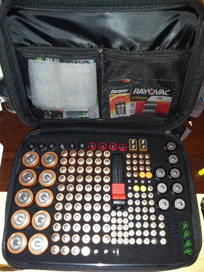 A reviewer's organizer filled with various batteries 