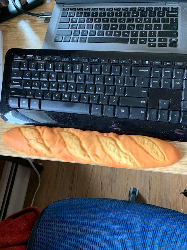 a baguette-shaped wrist rest in front of a keyboard