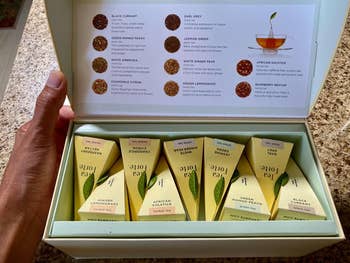 reviewer photo of the open sampler box showing nine boxes of team and a description sheet