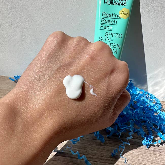 pump of sunscreen on back of hand