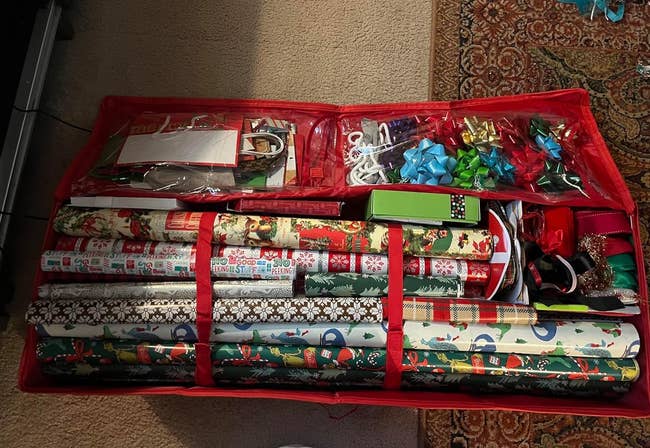 a reviewer's red storage bag filled with wrapping paper, bags, ribbons, bows
