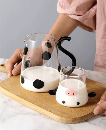 the carafe and tumbler both full of milk