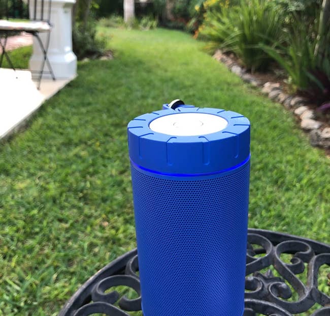 the blue speaker on a table outside