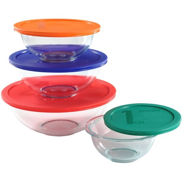 Four glass mixing bowls with colorful lids