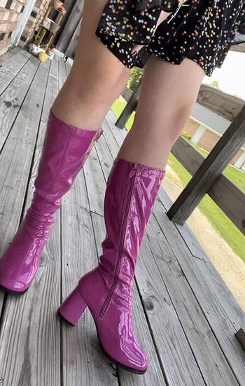 A reviewer wearing the boots in purple