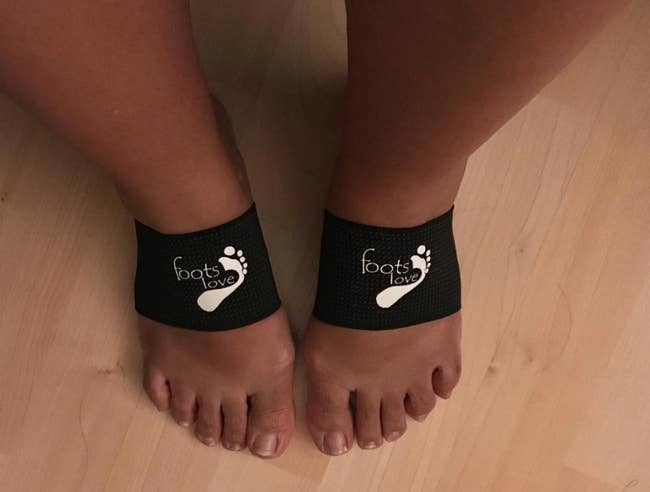 A pair of feet wearing black 