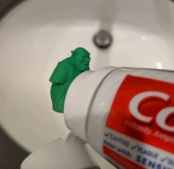 the toothpaste topper attached to a tube of toothpaste