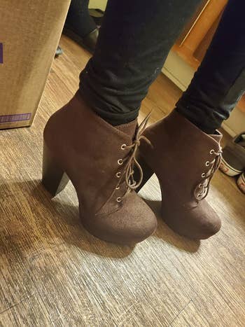 reviewer photo of them wearing brown chunky lace-up booties