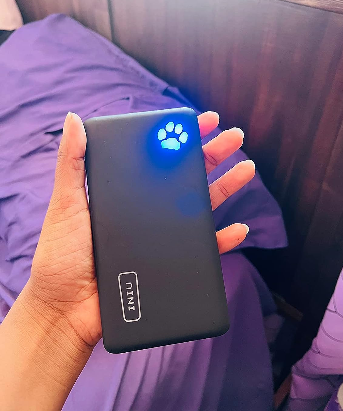 A reviewer holding the portable charger