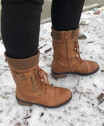 a reviewer wearing the boots in brown 