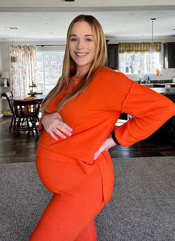 pregnant reviewer wearing set in orange