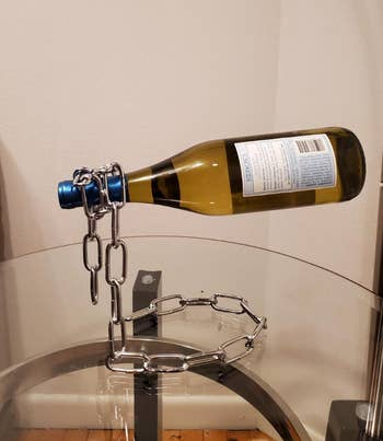 A wine bottle is suspended by a 