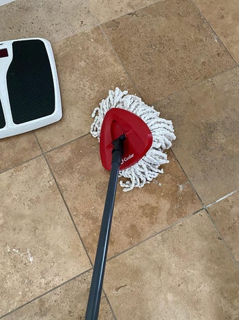 reviewer image using the mop to clean the floor