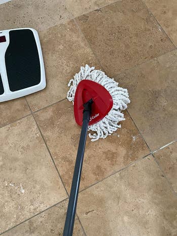 reviewer image using the mop to clean the floor