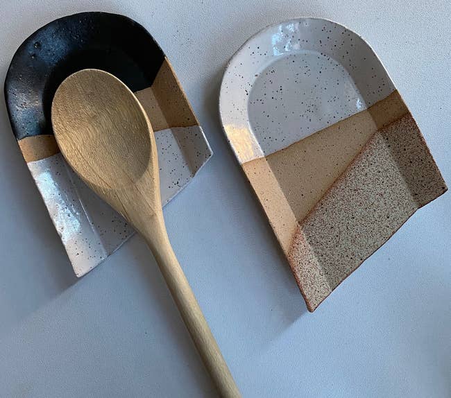the black and beige spoon rests, with a wooden spoon resting on the black one