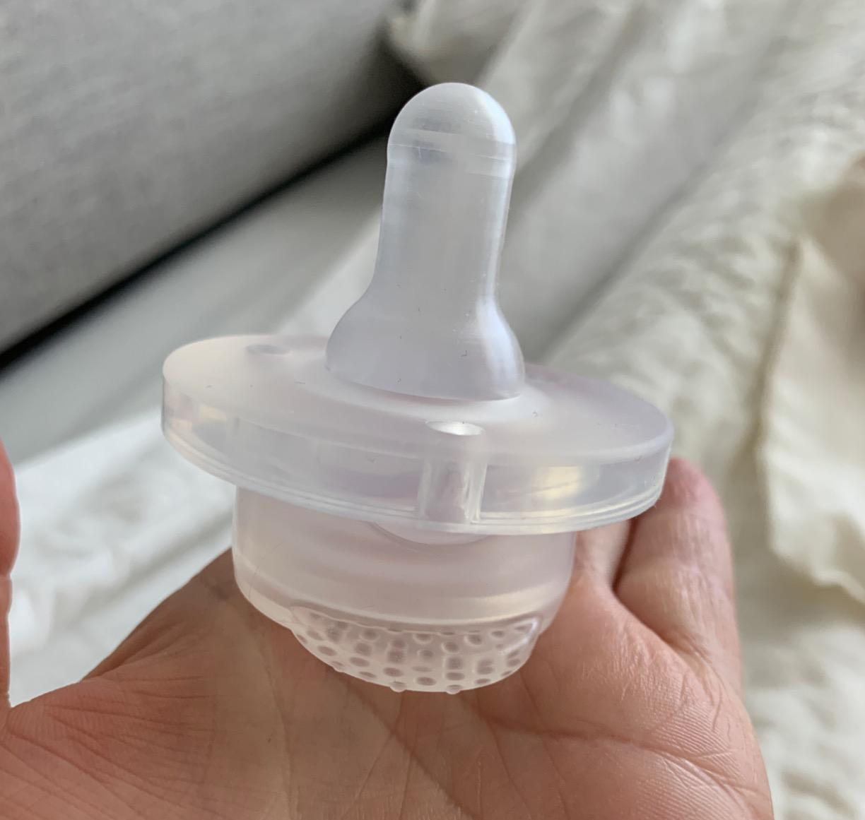 reviewer holding the freezable pacifier