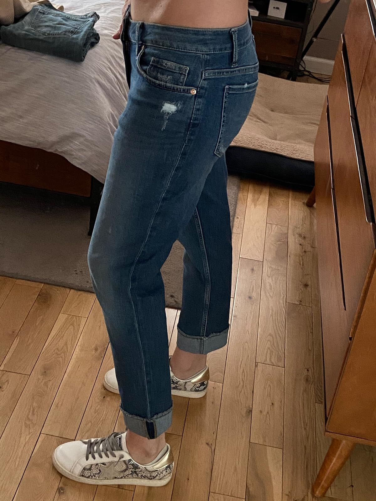 reviewer showing side view of the blue denim jenas