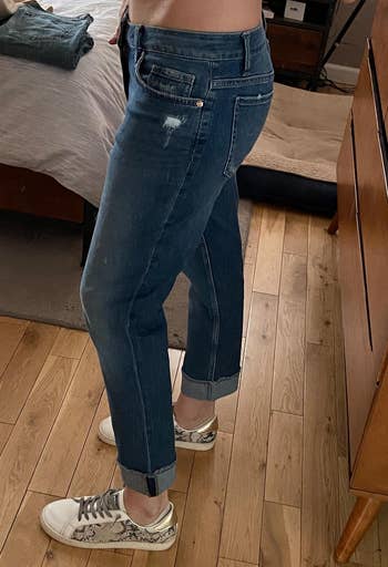 reviewer showing side view of the blue denim jenas
