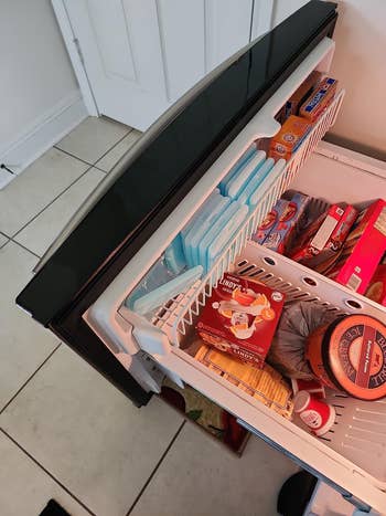 open freezer drawer with lots of the slim ice packs stored in a small space
