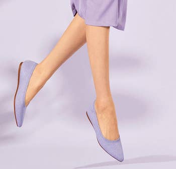 a model wearing pointed toe knit flats in light purple 