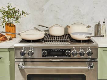 the set of pots in cream on a stove